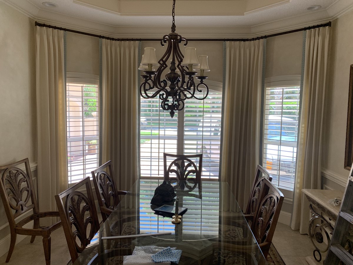 Custom draperies in a dining room bay window, Jacksonville FL
