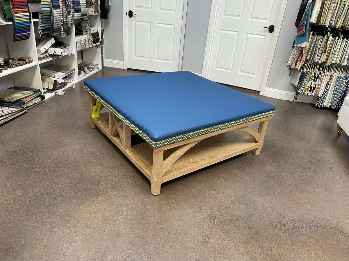 Custom blue upholstered bench on a rattan base, Jacksonville FL